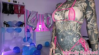 Melody Radford tries on sheer pink and blue micro bikini, showcasing her mature, skinny, tattooed body as a petite Australian amateur pornstar.