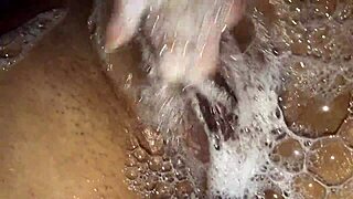Woman plays with her big natural tits in the shower while masturbating her pink pussy