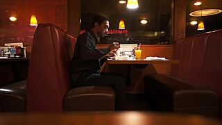 Indian Guy Enjoys American Breakfast in Public Outdoor Setting