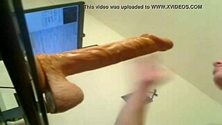 The blonde practices deep throating with a large dildo.