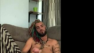 Dreddy emo punk dude strokes tattooed cock intriguingly