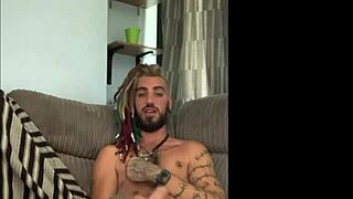 Dreddy emo punk dude strokes tattooed cock intriguingly