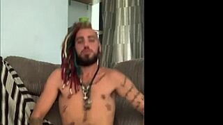 Dreddy emo punk dude strokes tattooed cock intriguingly