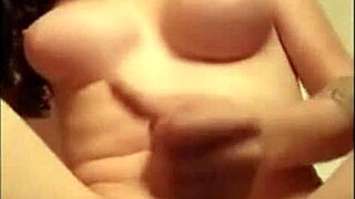 A performer on webcam engages in an intense solo activity with a toy, showcasing crossdressing and transsexual elements in a detailed session.