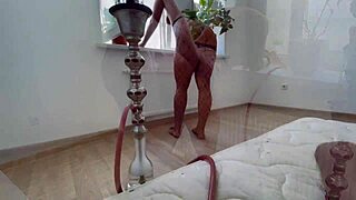 beautiful latina girl smokes hookah with her boyfriend