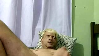 Young gay boy engages in intense sex with his partner on the bed.