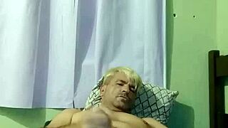 Young gay boy engages in intense sex with his partner on the bed.