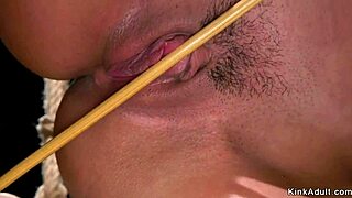 busty mistress spanks her bound slave hard. caning and choking follow in kinky session.