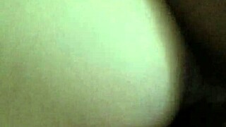 the girl moaned loudly as the big black cock pounded her ass in the dark room, stretching her wide with its monster size