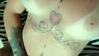 Tattooed beauty shows off her tan lines for the web