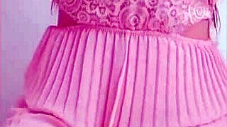 Young babe in pink dress masturbates her big tits and ass on camera