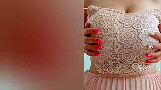 Young babe in pink dress masturbates her big tits and ass on camera