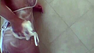 Hot blonde babe licks pussy backstage in shower closeup