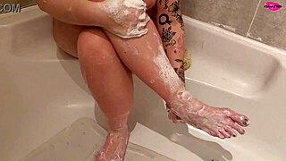 milf seductively washing her feet, teasing with shaved pussy?