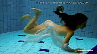 Kristy, a stunning brunette, flaunts her curves in the pool