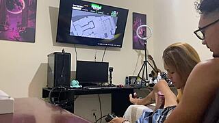 Sucking him quietly while he focuses on the video game.