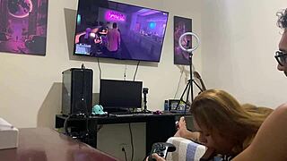 Sucking him quietly while he focuses on the video game.