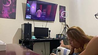 Sucking him quietly while he focuses on the video game.