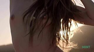 Petite and beautiful talia mint relaxes on the public beach