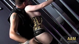 Latina couple uses dildo between bars in this fetish scene.