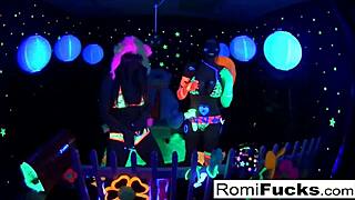Two busty lesbians enjoy black light party with shaved pussies