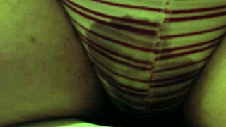 peeing in red striped underpants while sitting on the toilet