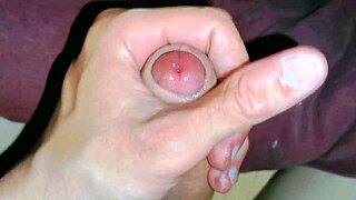 Beautiful mature gay gives handjob to big cock close up