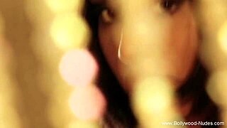 An asian brunette dances erotically, stripping and seducing with teasing moves, ripping clothes to reveal nude body in softcore scene.