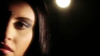 An asian brunette dances erotically, stripping and seducing with teasing moves, ripping clothes to reveal nude body in softcore scene.