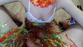 A couple shares intimate moments at a Hawaiian party.