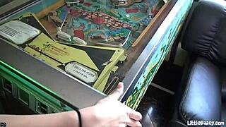 little bailey masturbates in the arcade using a dildo