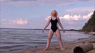 blonde woman bathing in the sea with a beautiful big ass in costume