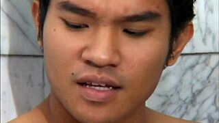 Interracial guys play fetish games in the shower.