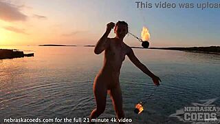 Hey, watch this pretty girl dance nude on the beach! 🔥