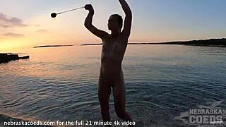Hey, watch this pretty girl dance nude on the beach! 🔥