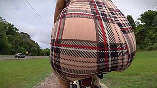 exhibitionist rides bike with butt plug, neighbor spies on tattooed ass.