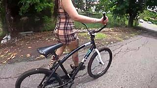 exhibitionist rides bike with butt plug, neighbor spies on tattooed ass.