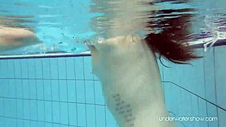 Roxalana cheh shows her shaved pussy underwater as a sexy redhead