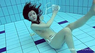 Roxalana cheh shows her shaved pussy underwater as a sexy redhead