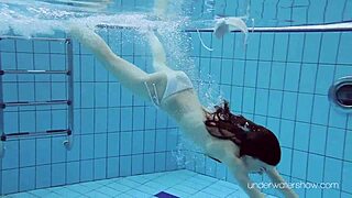 Roxalana cheh shows her shaved pussy underwater as a sexy redhead