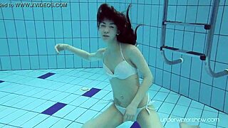 Roxalana cheh shows her shaved pussy underwater as a sexy redhead