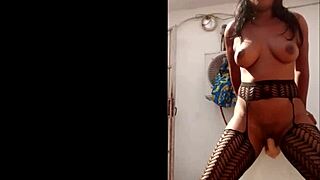 Masked ebony plays with huge dildo outdoors.