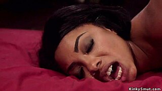 Ebony babe takes huge strap-on in tied-up anal domination.