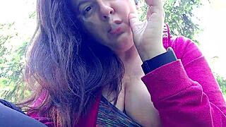 nicoletta is smoking in the public garden and flashing her big tits by pulling them out