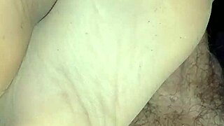 The man gently strokes his girl’s feet in sensual tan stockings