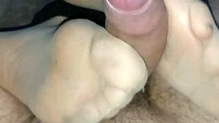 The man gently strokes his girl’s feet in sensual tan stockings