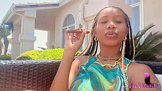 Smoker beauty jenna foxx relaxes outdoors with a cigarette.