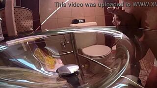 Milf gives handjob from behind in bathroom