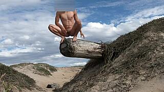 An athletic woman poses nude on the beach, teasing her cock before cumming in the plaza.