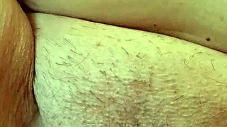 A mature woman plays with her pussy up close, talking dirty in a sexy voice